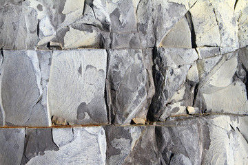 Grey shabby stone surface texture with cracks. Limestone rock background.