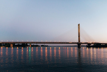 A huge bridge in the background of the sunset, which divides the city into two parts