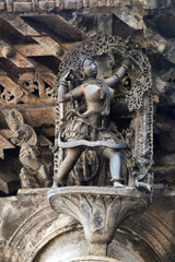 Shilabalika, celestial maiden, as a Huntress. Lady aiming arrow at the bird. Chennakeshava temple, Belur, Karnataka. Notice the hairstyle.