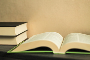 Education concept: open book, books in the background, selective focus