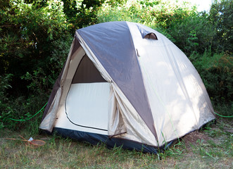 Single tent standing in the forest.