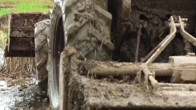 Slow motion : People using  big tractor in rice field