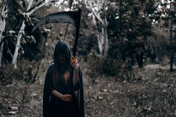 Psychopom with scythe horor halloween at dark forest, demon or devil ghost dangerous kill soul...