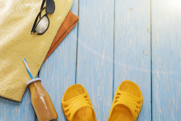 summer vacation on the beach. Yellow slippers, sunglasses and a cocktail.
