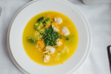 Dietary soup. Bowl plate of soup with vegetables, meatballs made of turkey and chicken, top view
