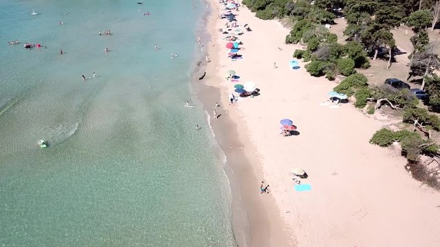 Drone fly over a sandy beach with blue sea