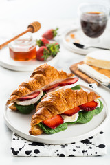 Croissant with strawberries, brie cheese or Camembert. Marble background