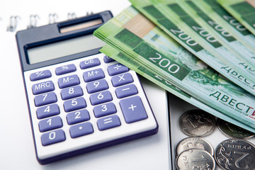 Fototapeta premium business still-life from a calculator and a bundle of russian banknotes 200 rubles
