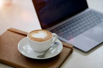 Coffee cup and book on desk.