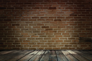 Dark wooden over grunge red brick wall. Red brick wall and wooden floor.