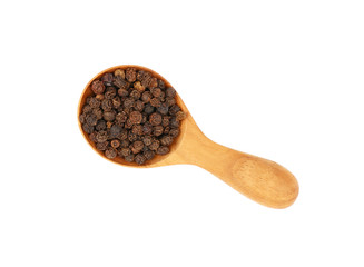 Wooden scoop spoon full of black peppercorns