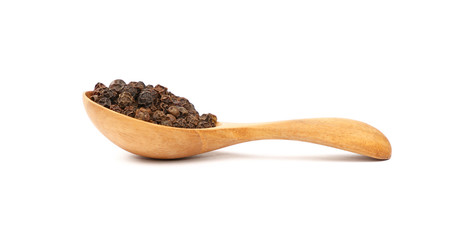Wooden scoop spoon full of black peppercorns