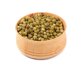 Wooden bowl full of green peppercorns