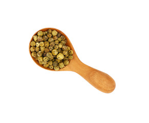 Wooden scoop spoon full of green peppercorns