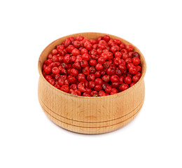 Wooden bowl full of pink peppercorns