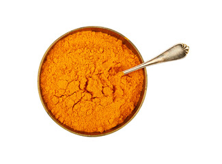 One bronze metal bowl full of yellow turmeric powder
