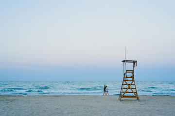Lifeguard watchtower on the beach at sunset.