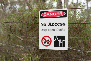 Danger No Access Deep open Shafts safety warning sign in front of closed gold mine Jupiter Diggings in Adelaide Hills South Australia