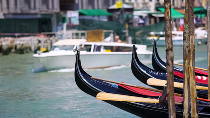 Fototapeta na wymiar Water taxi carrying tourists in Venice, gondolas parked along canal, sightseeing
