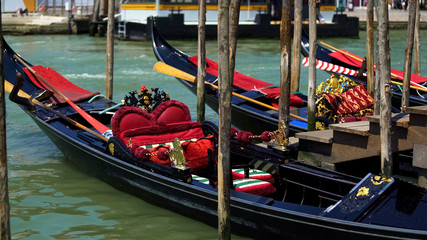 Fototapeta na wymiar Romantic gondolas moored at Grand Canal, traditional Venetian transport, travel