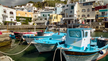 Obraz premium Beautiful fishing boats parked near quay in resort town, rural area in Italy