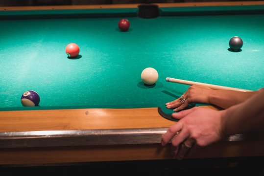 Couple playing snookers in the club