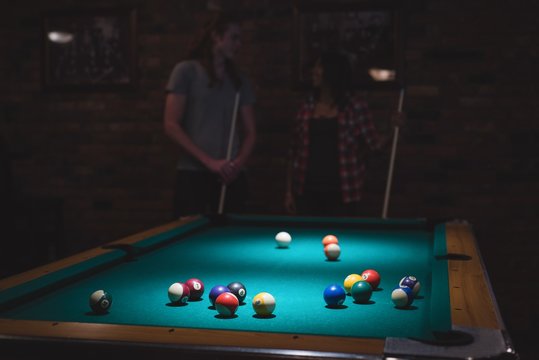 Couple playing snookers in the club