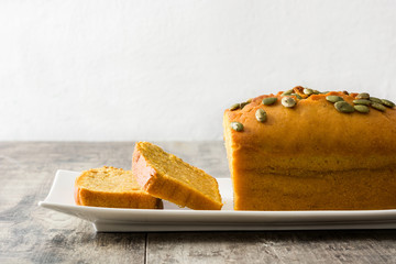 Homemade pumpkin bread on wooden table.