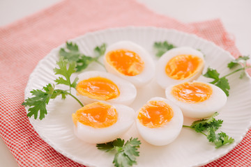Close up medium soft boiled duck egg portion on white dish