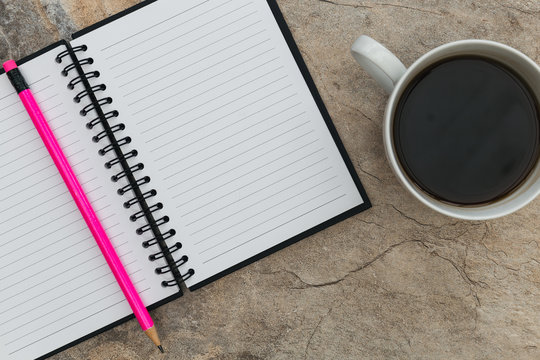 Notebook paper pencil coffee cup marble background