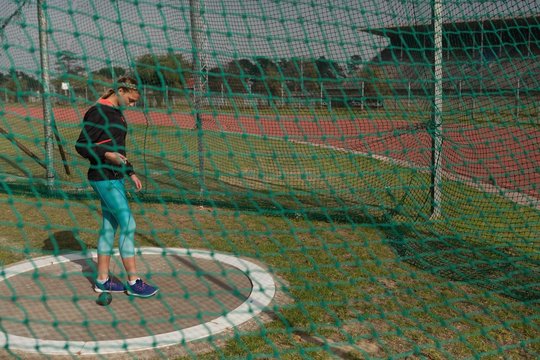 Female athlete practicing shot put