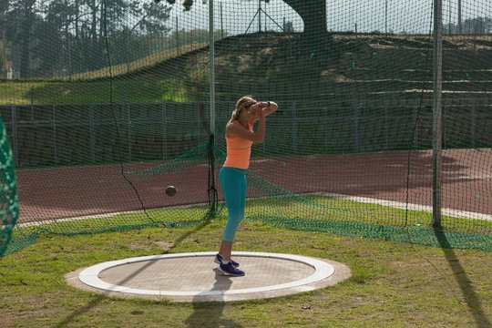Female athlete practicing shot put