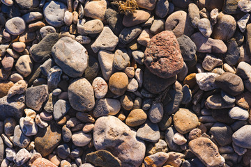 View of the Mediterranean Sea with shingle beach an waves.