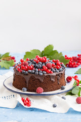 Cake with fresh berries on white plate.