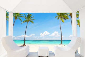 Fototapeta na wymiar View of the beautiful beach through a Balinese bed