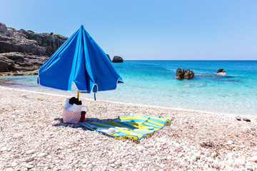 Blue umbrella by the blue sea