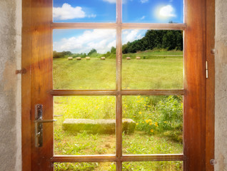 A peaceful rural landscape outside the rustic-style doors