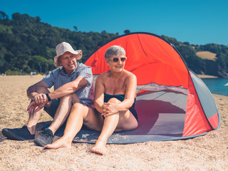 Senior couple sitting in beach shelter