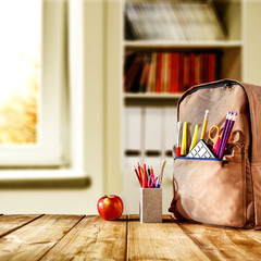 Wooden table with school backpack and free space for your decoration. 