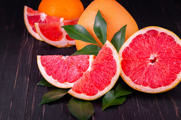 orange and grapefruit juice On a wooden black background