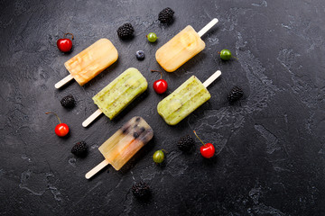 Photo of frozen juice on stick, blackberry,cherry, gooseberries