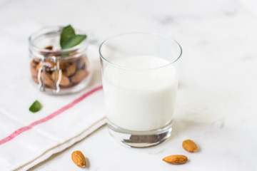 Almond milk in a glass on a white background. Organic vegan milk