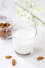 Almond milk in a glass on a white background. Organic vegan milk