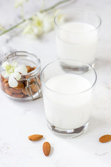 Almond milk in a glass on a white background. Organic vegan milk