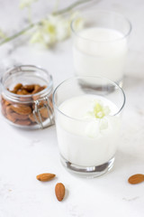 Almond milk in a glass on a white background. Organic vegan milk