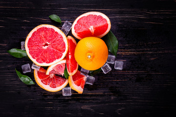 orange and grapefruit juice On a wooden black background