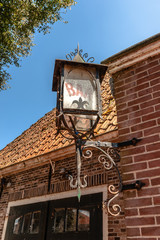 Old shabby lantern hanging on a brick wall