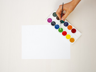 Artist holding a white paper. Top view. can place you. text ad information