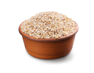 Barley grits in wooden bowl isolated on white