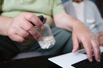 Senior man checking prescription for medicine with laptop. Retirement and technology innovation, health care, gadgets, modern lifestyle concept